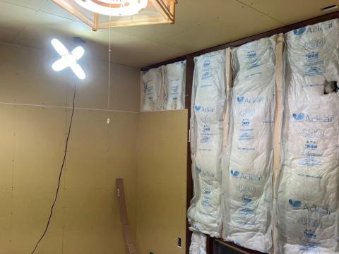 西小山の戸建てで断熱材充填後にボードで仕上げをする写真