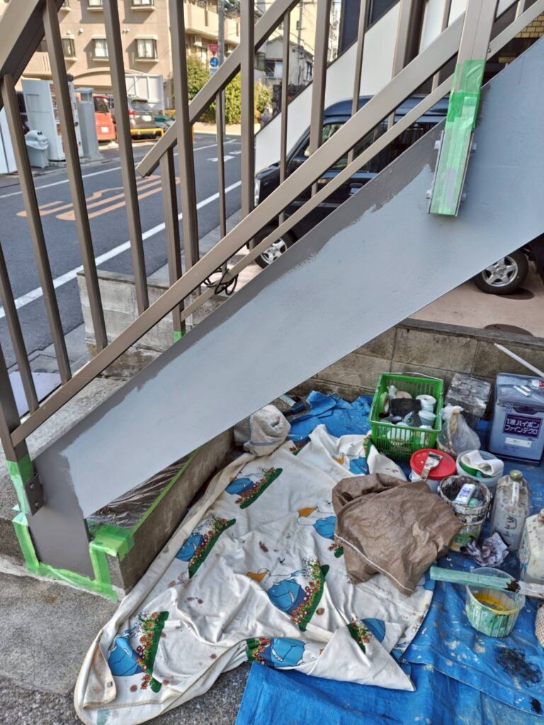 品川区西五反田で鉄部手すりの塗装階段下の養生と塗装道具の写真